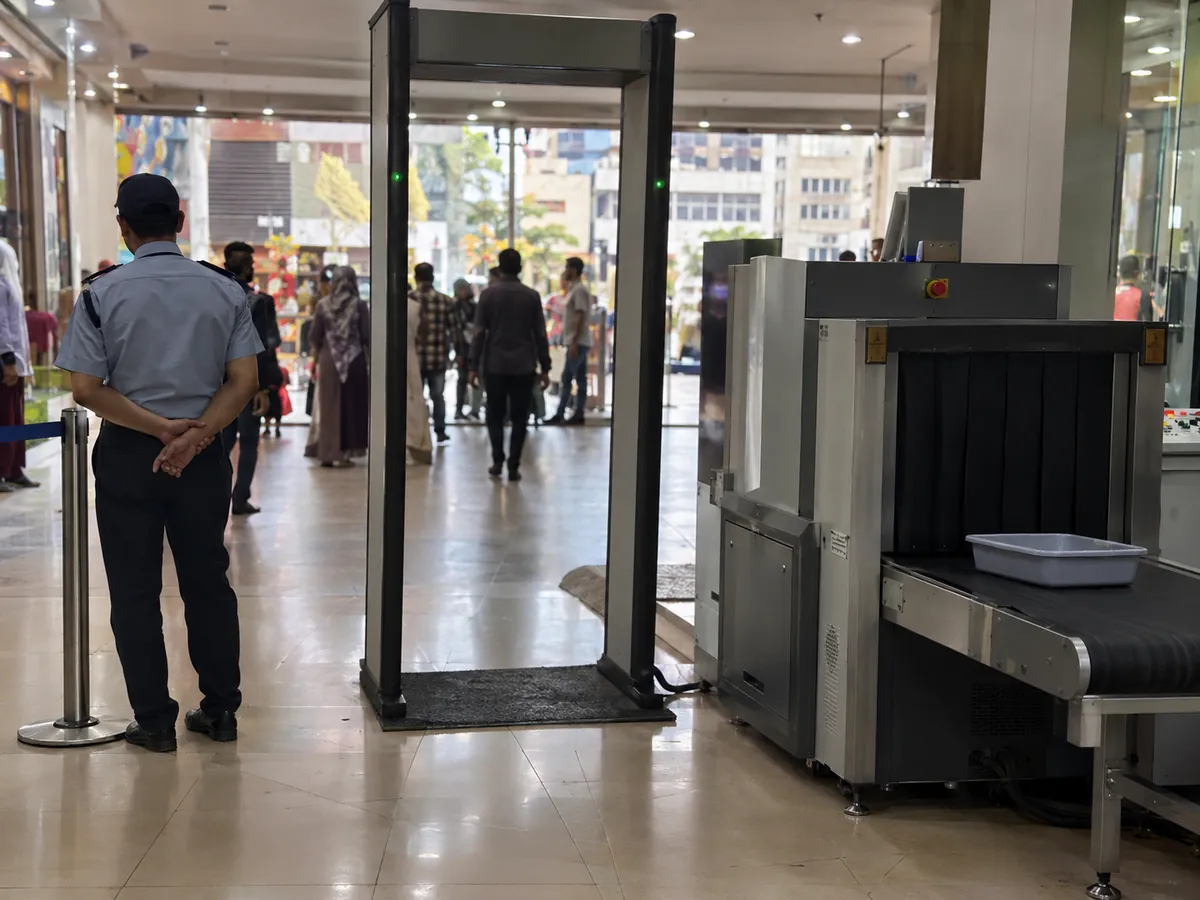 Walk-through metal detector and X-ray baggage scanner at a shopping mall entrance